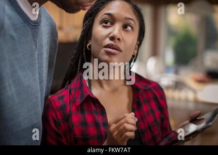 Cropped shot of mid adult couple using digital tablet in kitchen Stock Photo