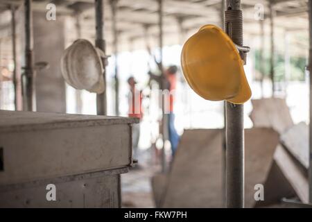 Male builders working on scaffolding on construction site Stock Photo