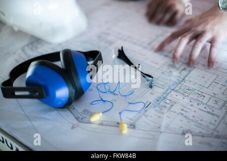 Close up of male hands on blueprint in construction site Stock Photo