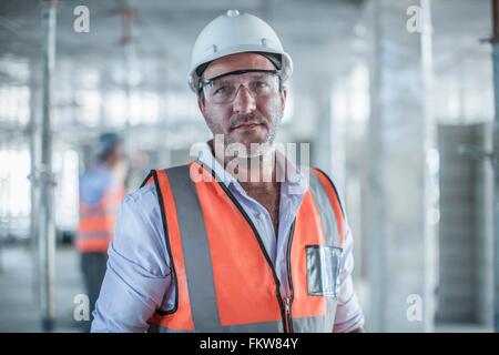 Portrait of mid adult male site manager on construction site Stock Photo
