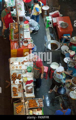 On Sunday, Bangkok street cooking at Sala Daeng (Thailand). The slightest patch of pavement is taken up by food stalls. Stock Photo