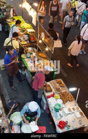 On Sunday, Bangkok street cooking at Sala Daeng (Thailand). The slightest patch of pavement is taken up by food stalls. Stock Photo