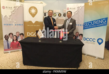 Dubai. 10th Mar, 2016. General Manager of Bank of China Abu Dhabi branch Tian Jun (R) shakes hands with CEO of Dubai Gold and Commodities Exchange (DGCX) Gaurang Desai after the signing ceremony in Dubai, the United Arab Emirates, on March 10, 2016. The commodities and currency derivatives bourse DGCX said here Thursday that Bank of China was appointed as a settlement bank for Dubai Commodities Clearing Corporation (DCCC), a subsidiary of DGCX, United Arab Emirates (UAE) state news agency WAM reported. © Xinhua photo/Alamy Live News Stock Photo