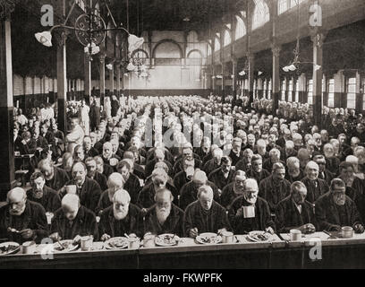 Dinnertime for the inmates of a workhouse, London, England in the late 19th century. Workhouses were places where those unable to support themselves were offered accommodation and employment. Stock Photo