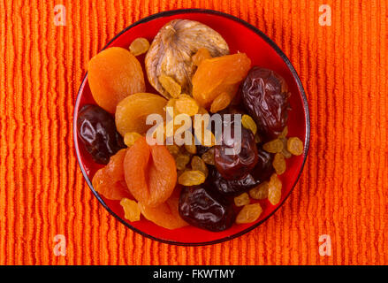 various dried fruits on the textile orange background Stock Photo