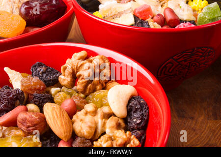 various different mixed nuts and raisins on wooden background Stock Photo