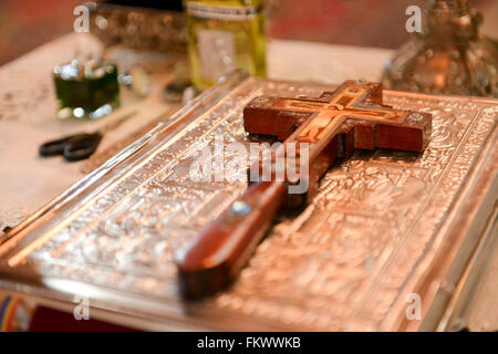 Cross placed on the Bible in a church Stock Photo