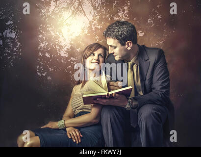 young couple in love sitting in park Stock Photo