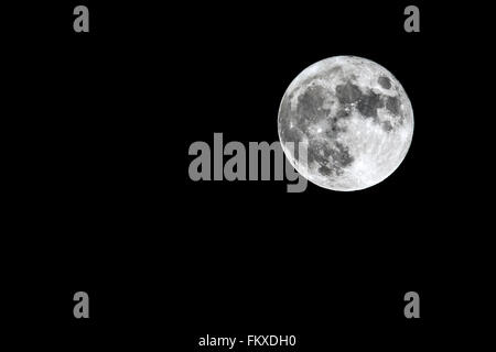 The full Moon is seen isolated on a black background. High contrast, high resolution image taken with a full frame dslr camera. Stock Photo