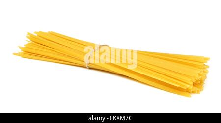 Uncooked dry fettuccine pasta tied in a bundle isolated on a white background Stock Photo