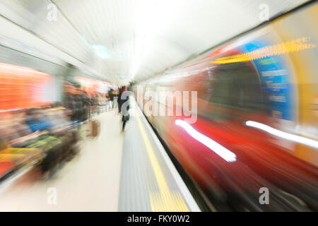 Motion blurred image of a London Underground train arriving at a station platform, Green Park Station, London UK Stock Photo