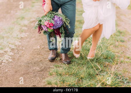 Bride's and groom's foot on the ground close up Stock Photo