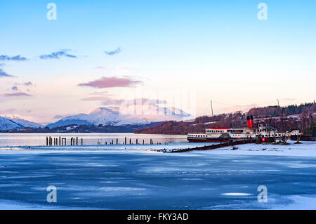 A winter view of the majestic and impressive ben lomond from across a partially frozen loch lomond near the scottish town of bal Stock Photo