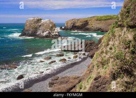 A typical scene on a sunny day at the rugged Oregon coast at Yaquina Cove, by the lighthouse in Newport. Stock Photo