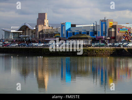 The seafront at New Brighton, Wallasey, UK with buildings reflected in the still waters of the boating lake. Stock Photo