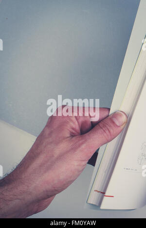 hands turning pages in empty book with blank pages Stock Photo