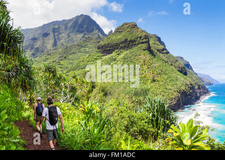 Hikers on the Kalalau Trail on Kauai near Hanakapiai Beach Stock Photo