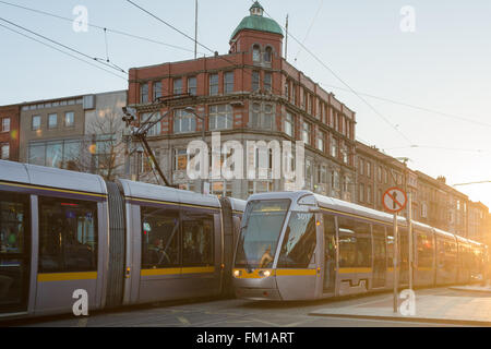 Two Dublin Luas trams on Abbey Street crossing O'Connell Street, Dublin, Ireland Stock Photo