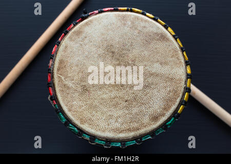 Djembe with drum sticks Stock Photo