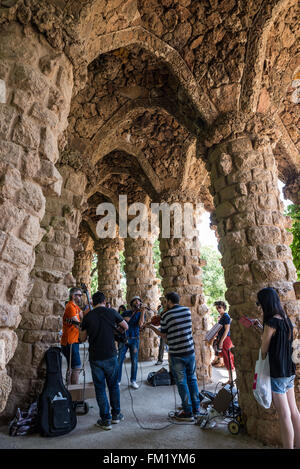 Musicians in Park Guell located on Carmel Hill in La Salut neighborhood in the Gracia district of Barcelona, Spain Stock Photo