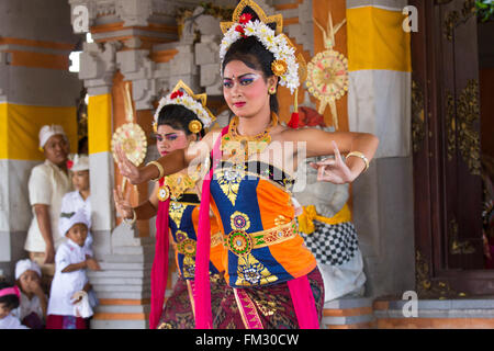 Indonesia, Bali, Girls Dressed in Traditional Dancing Costume, Legong Dancers with Frangipani floral headdress. Stock Photo