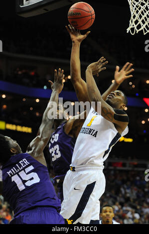 West Virginia forward Jonathan Holton (1) is fouled as he drives to the ...