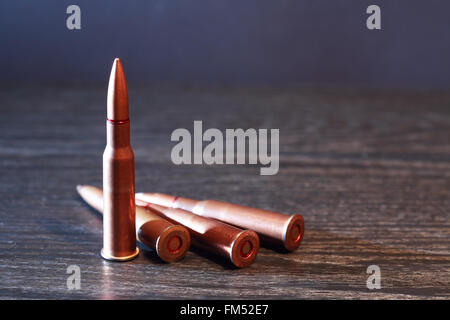 Single rifle bullet on wooden background. High resolution photo Stock Photo  - Alamy