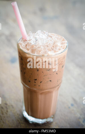 iced cocoa in a glass on wood background, vintage cocoa Stock Photo