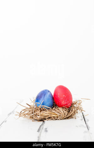 painted hen egg in a bird nest Stock Photo