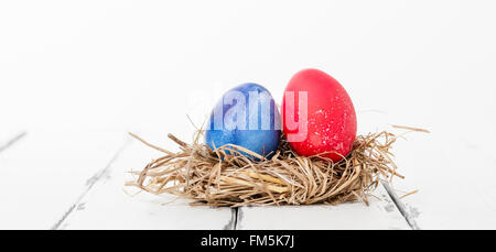 painted hen egg in a bird nest Stock Photo