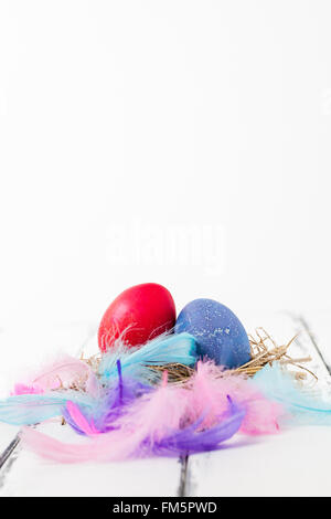 Easter image with red and blue eggs and feathers Stock Photo