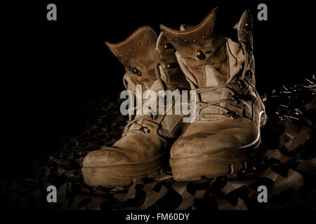 military boots on camouflage net and black backround Stock Photo - Alamy