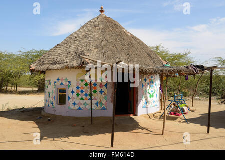 Traditionally decorated hut in the tribal village on the desert in India in the Gujarat state Stock Photo