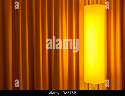 floor lamp ahead curtain on the left Stock Photo