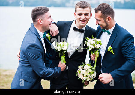 Three friends, groom with groomsman having fun Stock Photo