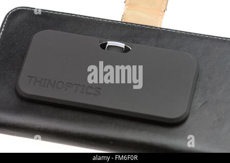 ThinOptics reading glasses in a case stuck to a mobile phone case. Stock Photo