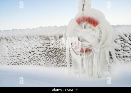 Frozen life buoy with icicles at a port i the winter by a frozen sea. Roslagen, Uppland, Sweden, Scandinavia Stock Photo