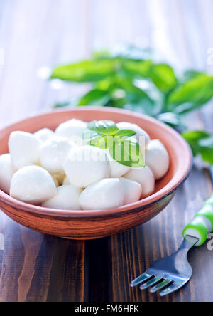 mozzarella cheese in bowl and on a table Stock Photo