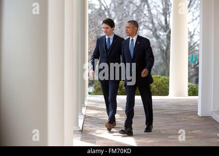 U.S. President Barack Obama walks with Canadian Prime Minister Justin Trudeau through the Colonnade to the Rose Garden for a joint press conference at the White House March 10, 2016 in Washington, DC. This is the first state visit by a Canadian Prime Minister in 20-years. Stock Photo