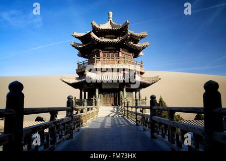 China, Gansu Province, Dunhuang, Crescent Lake (Yueyaquan), temple in the desert surrounded by frozen sand dunes