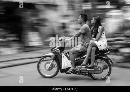 A moped travelling through Hanoi, Vietnam Stock Photo