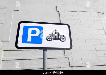 Road sign for parking motorbikes only, against a white wall in the background England UK. Stock Photo