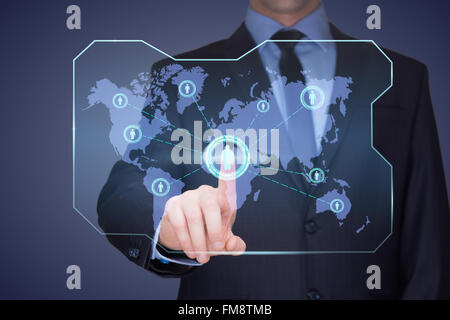 handsome businessman touching a world map on the screen showing global connection between different continents. Stock Photo