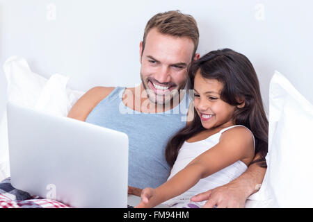 Father and daughter using laptop Stock Photo