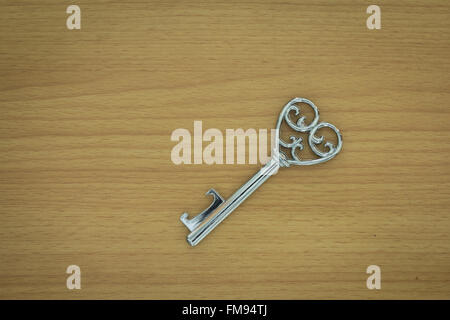 Heart shape key on a wooden background Stock Photo