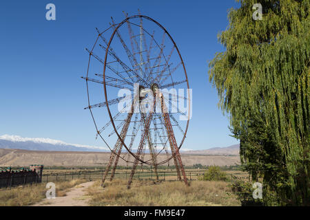 A photograph of an old and abandoned ferris wheel in Toktogul, Kyrgyzstan. Stock Photo