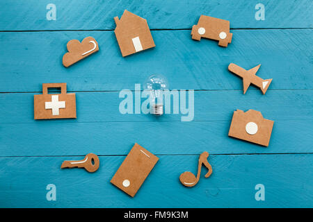 Cardboard web icons  and light bulb on blue background Stock Photo
