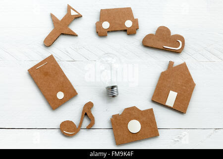 Cardboard web icons  and light bulb on blue background Stock Photo