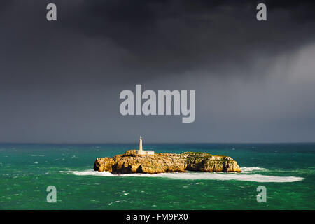 Mouro lighthouse in Santander with stormy clouds; Stock Photo