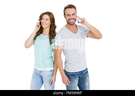 Happy young couple talking on mobile phone Stock Photo